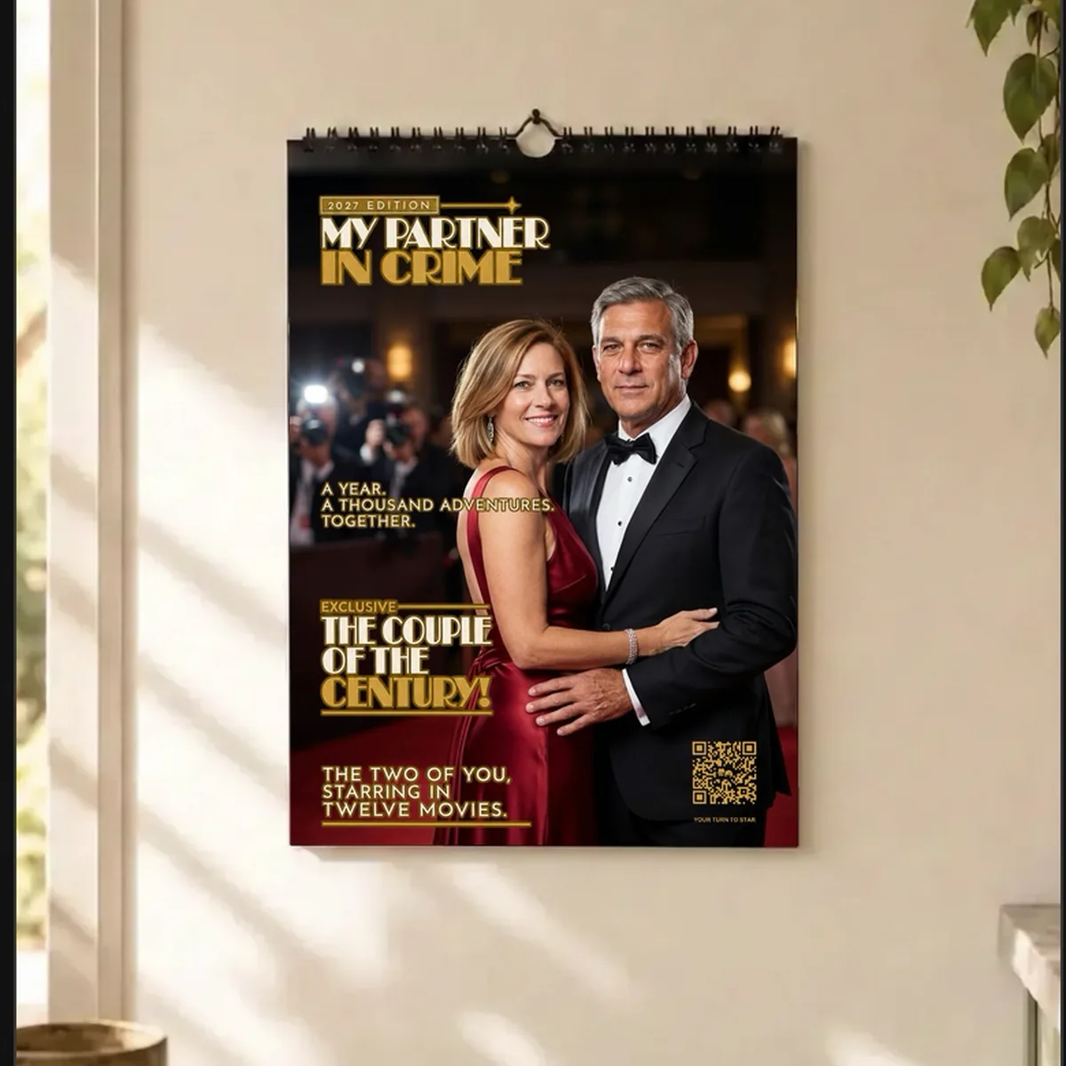 The personalised 2027 Partner in Crime calendar hanging on a bright kitchen wall.